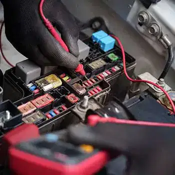 car fuse box electrical testing with multimeter.technician checking automotive fuses.