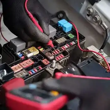 car fuse box electrical testing with multimeter.technician checking automotive fuses.
